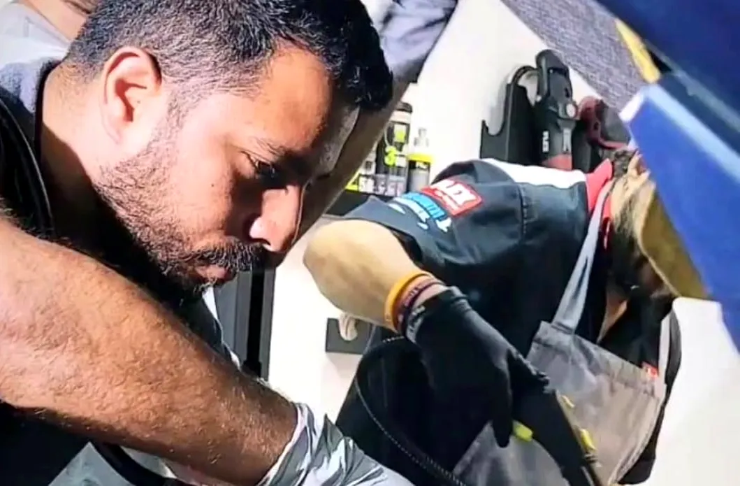 The founder of Blessed Holy Detailing Services at work on a vehicle